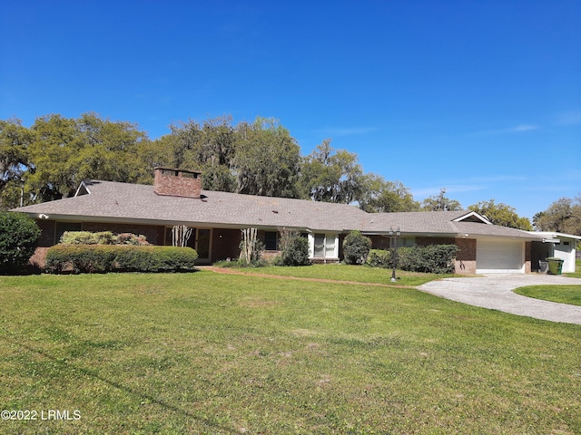 ranch-style home featuring a garage and a front yard