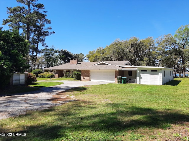 single story home featuring a garage and a front yard