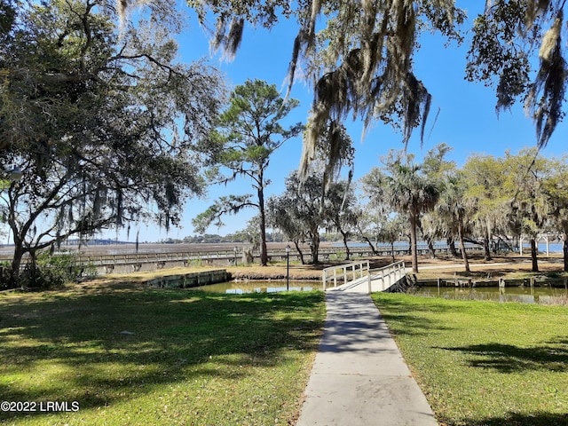 exterior space featuring a water view and a yard