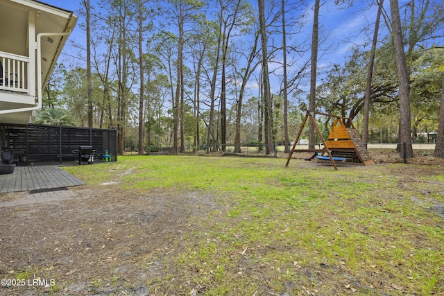 view of yard featuring a playground and fence