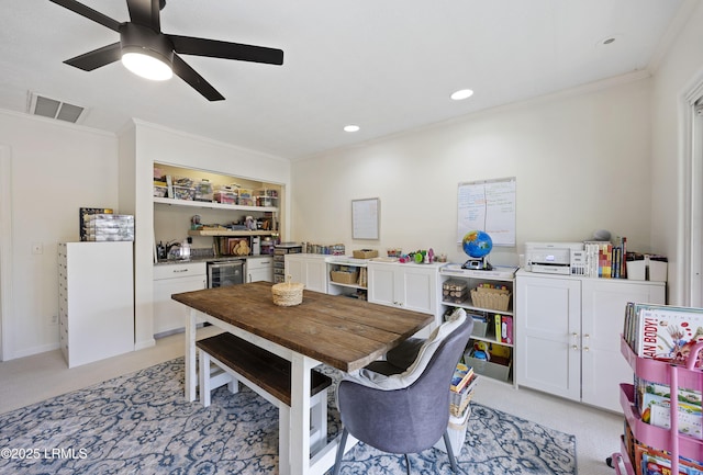 dining room featuring light carpet, wine cooler, visible vents, and crown molding