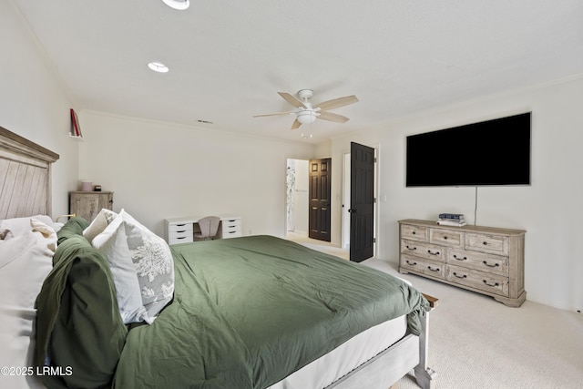 carpeted bedroom with a ceiling fan and crown molding