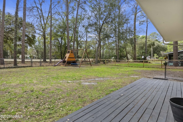 view of yard with a fenced backyard, a playground, and a wooden deck