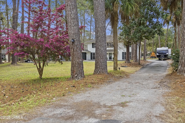 exterior space featuring driveway and a front yard