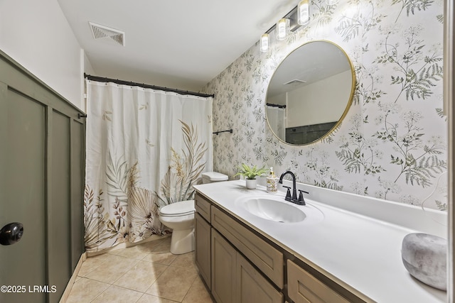 bathroom with visible vents, toilet, vanity, tile patterned flooring, and wallpapered walls