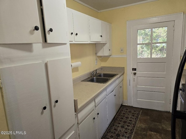 kitchen with white cabinetry, sink, and ornamental molding