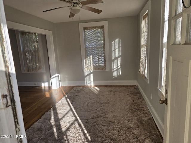 entryway featuring dark wood-type flooring and ceiling fan