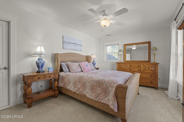 bedroom with light colored carpet and ceiling fan