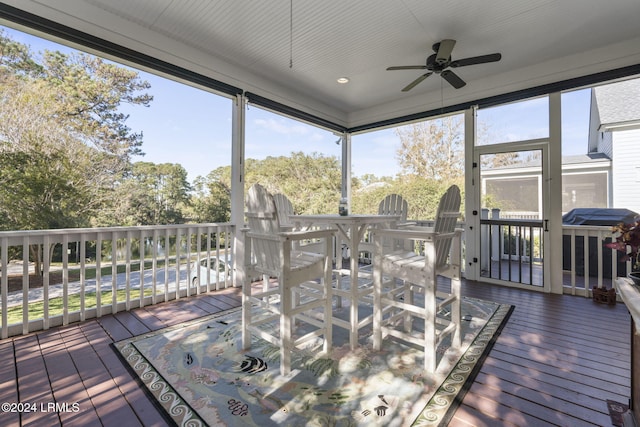 sunroom / solarium with plenty of natural light and ceiling fan