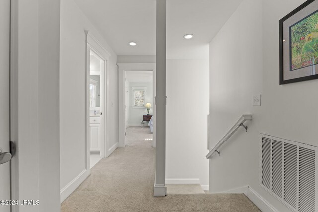 corridor with light colored carpet