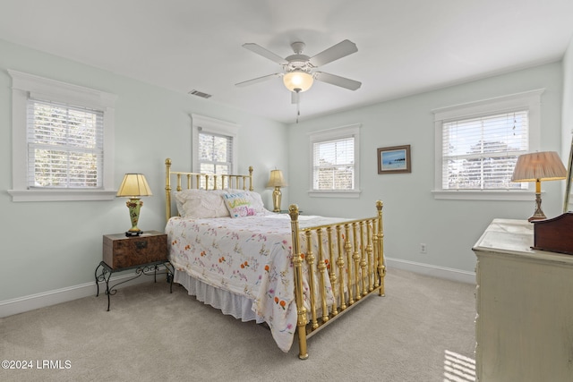 bedroom featuring ceiling fan and light carpet