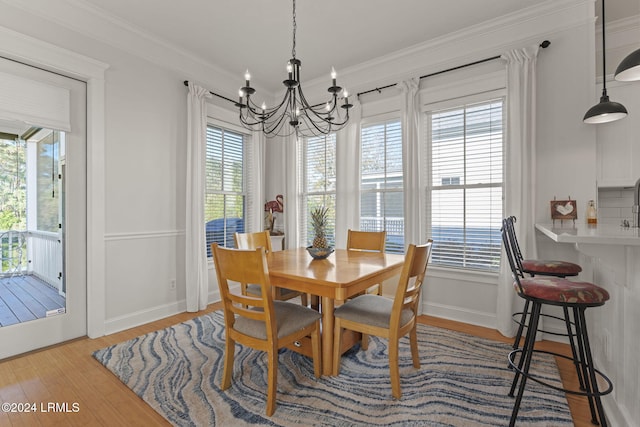 dining room with a notable chandelier, light hardwood / wood-style flooring, and a wealth of natural light