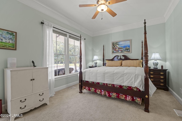 carpeted bedroom with ornamental molding and ceiling fan