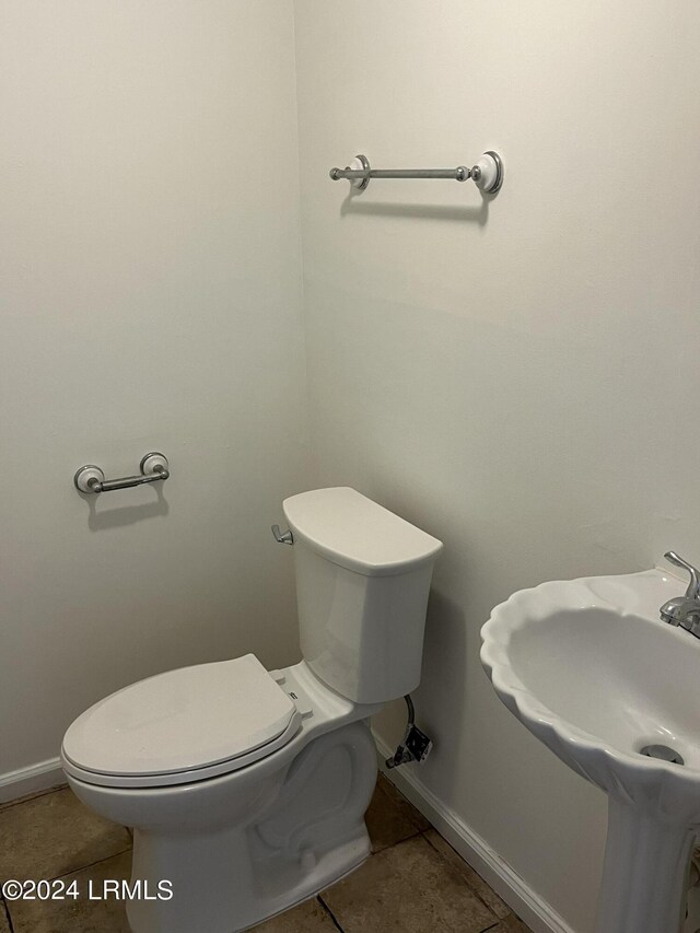 bathroom featuring tile patterned floors, toilet, and sink