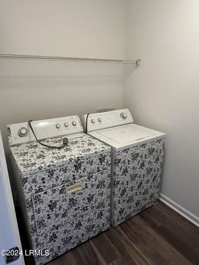 washroom featuring washing machine and dryer and dark hardwood / wood-style flooring