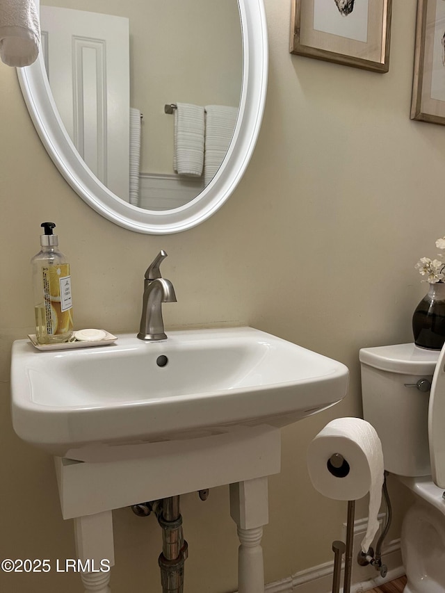 bathroom featuring toilet and a sink