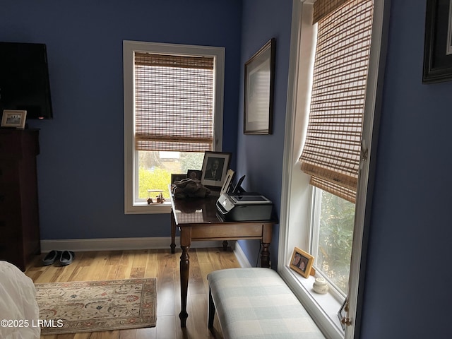 office space with wood finished floors and baseboards