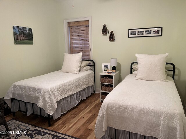 bedroom with dark wood finished floors