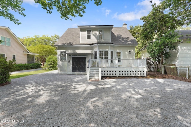 19 Brisbane Dr, Beaufort, SC 29902 - view of front of house with roof with shingles, driveway, a wooden deck, and a chimney