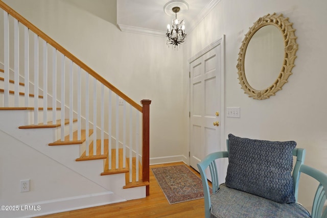19 Brisbane Dr, Beaufort, SC 29902 - foyer entrance with baseboards, a chandelier, crown molding, stairway, and wood finished floors