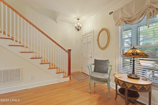 19 Brisbane Dr, Beaufort, SC 29902 - interior space with visible vents, ornamental molding, a chandelier, stairway, and wood finished floors