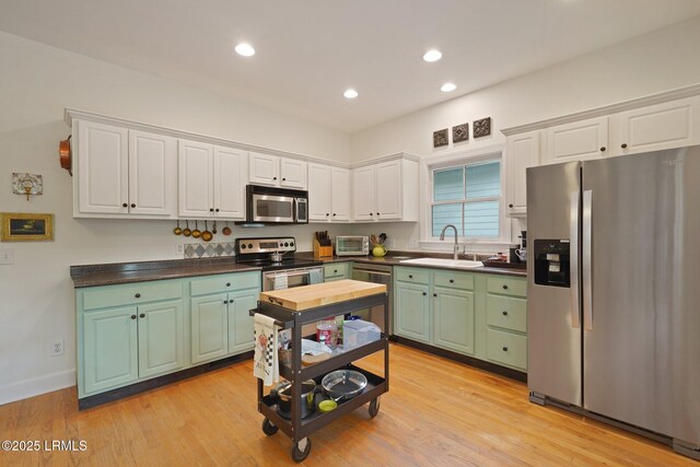 19 Brisbane Dr, Beaufort, SC 29902 - kitchen featuring recessed lighting, dark countertops, white cabinets, stainless steel appliances, and a sink
