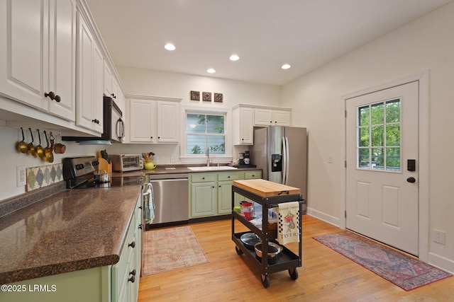 19 Brisbane Dr, Beaufort, SC 29902 - kitchen featuring dark countertops, green cabinetry, stainless steel appliances, light wood finished floors, and a sink
