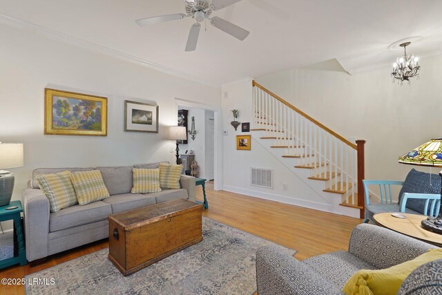 19 Brisbane Dr, Beaufort, SC 29902 - living room with stairway, crown molding, visible vents, ceiling fan with notable chandelier, and wood finished floors