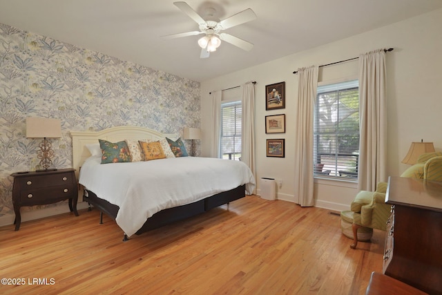 19 Brisbane Dr, Beaufort, SC 29902 - bedroom featuring multiple windows, baseboards, light wood finished floors, and wallpapered walls