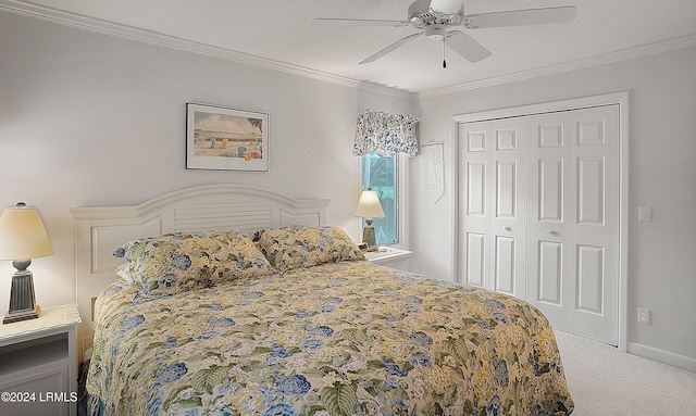 carpeted bedroom with crown molding, a textured ceiling, ceiling fan, and a closet