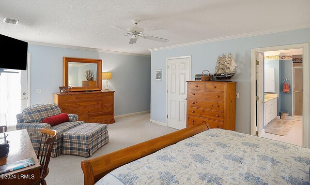 bedroom featuring crown molding, ceiling fan, ensuite bathroom, and a textured ceiling