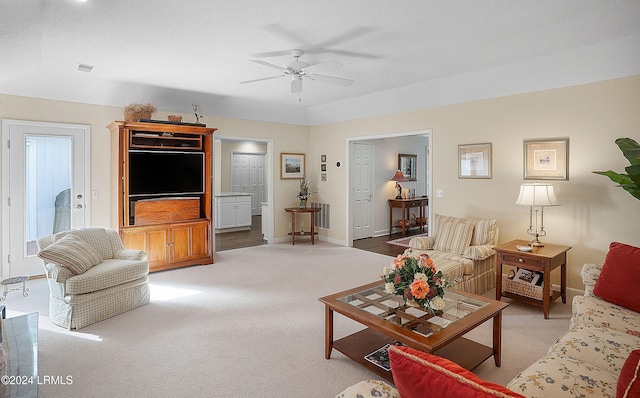 living room featuring vaulted ceiling, carpet floors, a textured ceiling, and ceiling fan