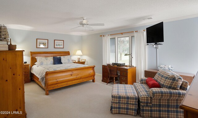 bedroom featuring crown molding, a textured ceiling, light colored carpet, and ceiling fan