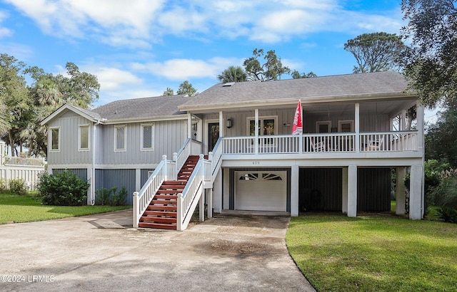 beach home with a porch, a garage, and a front yard