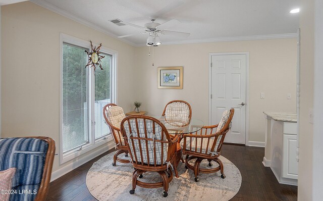 dining area with crown molding, ceiling fan, and dark hardwood / wood-style flooring