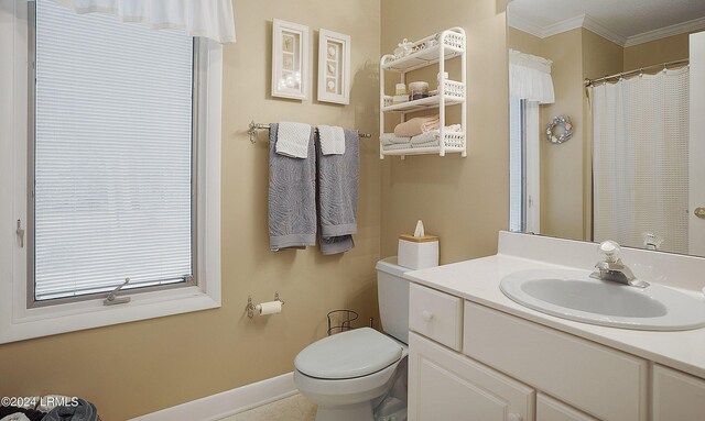 bathroom with ornamental molding, curtained shower, vanity, and toilet