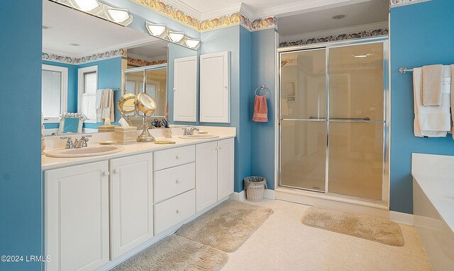 bathroom with vanity, crown molding, and a shower with door