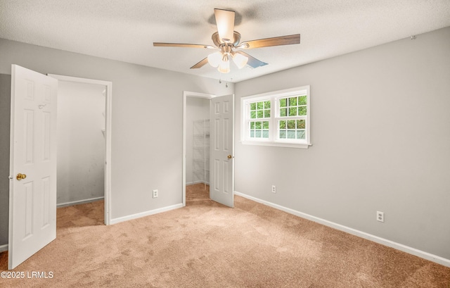 21 Planters Cir, Beaufort, SC 29907 - unfurnished bedroom with a spacious closet, light carpet, a closet, a textured ceiling, and a ceiling fan