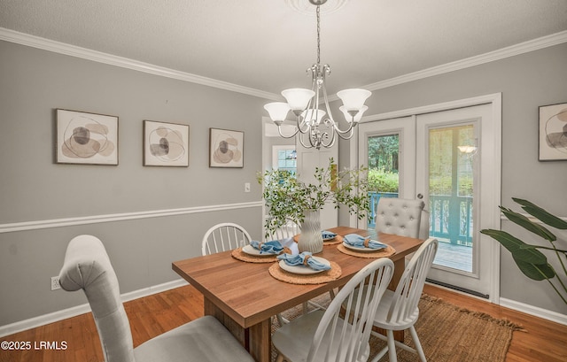 21 Planters Cir, Beaufort, SC 29907 - dining space with ornamental molding, a chandelier, and wood finished floors