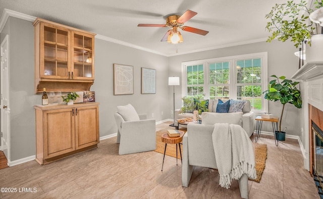 21 Planters Cir, Beaufort, SC 29907 - living room featuring a glass covered fireplace, a ceiling fan, and crown molding