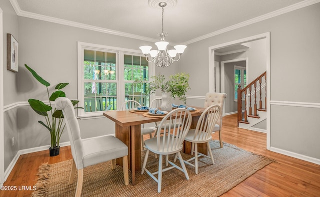 21 Planters Cir, Beaufort, SC 29907 - dining space with stairway, a chandelier, light wood finished floors, and crown molding
