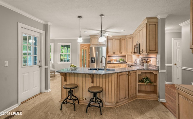 21 Planters Cir, Beaufort, SC 29907 - kitchen with stainless steel appliances, dark stone countertops, tasteful backsplash, a peninsula, and a breakfast bar