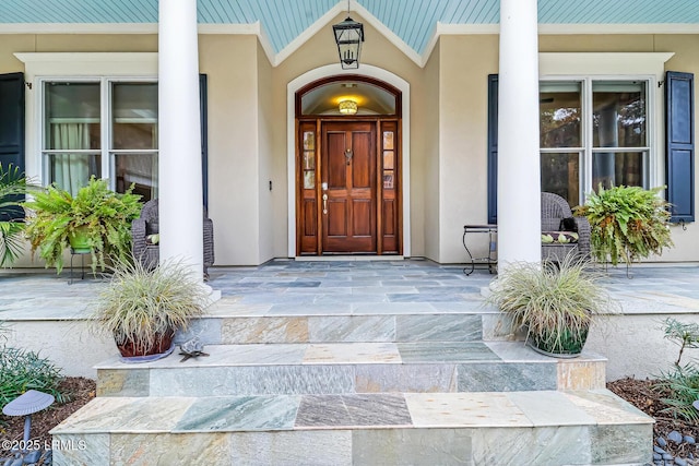 view of exterior entry featuring a porch