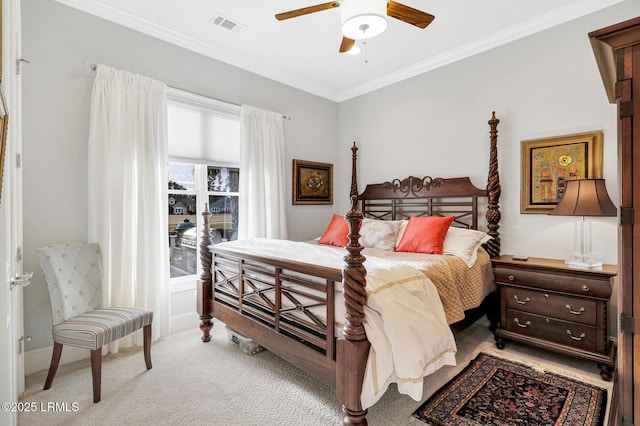 carpeted bedroom with ornamental molding and ceiling fan