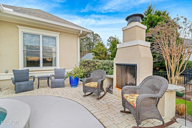 view of patio / terrace with exterior fireplace