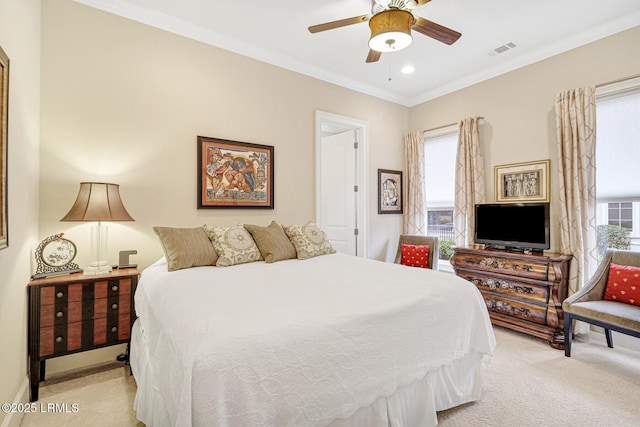 bedroom with crown molding, ceiling fan, and light carpet