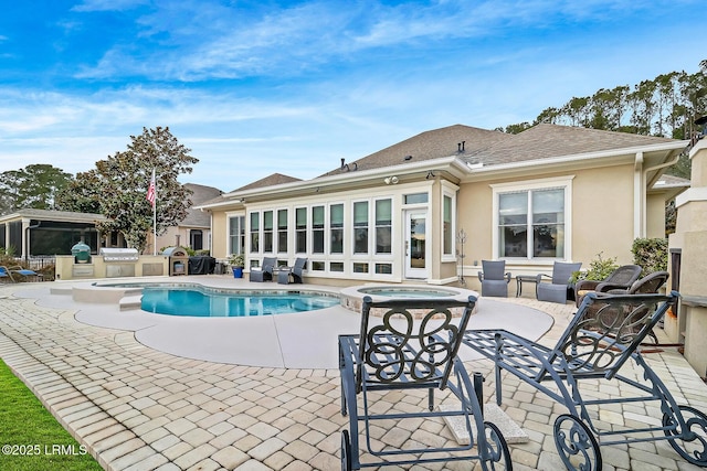 view of pool with an in ground hot tub, area for grilling, and a patio