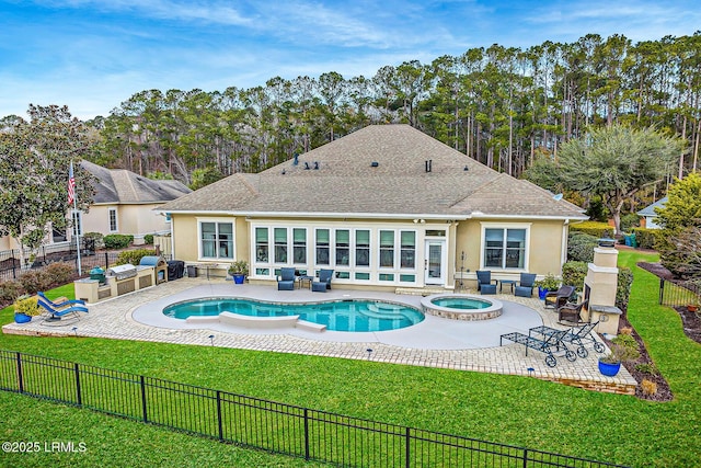 view of pool featuring an in ground hot tub, a yard, and a patio