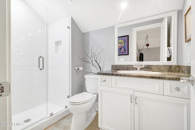 bathroom featuring vaulted ceiling, a shower with shower door, tile patterned flooring, vanity, and toilet