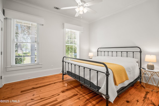 2211 Wilson Dr, Beaufort, SC 29902 - bedroom featuring wood finished floors, ornamental molding, and a ceiling fan